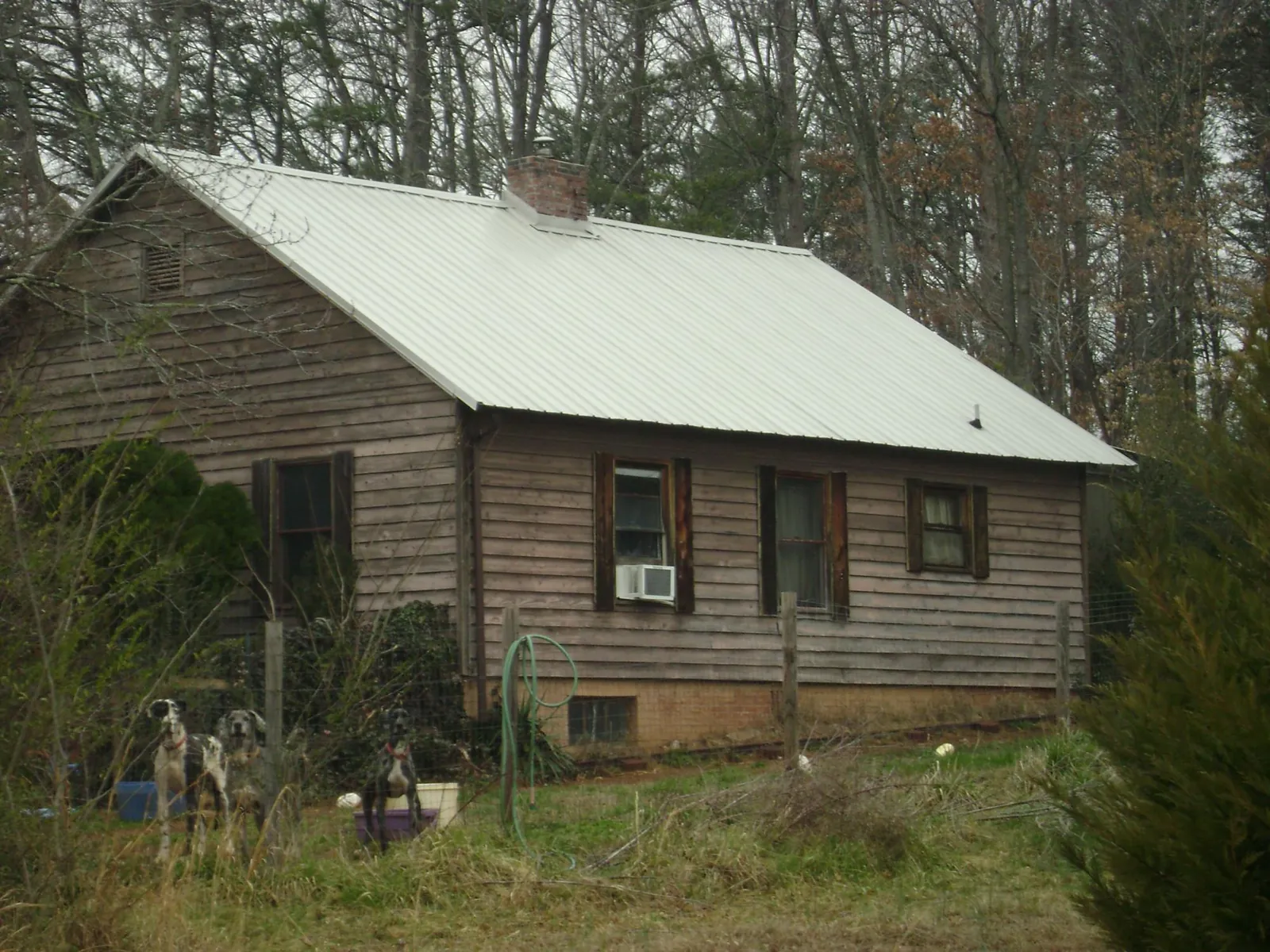 White metal roof on an old wood sided farmhouse, from a Metal Roof Installation job in Norton